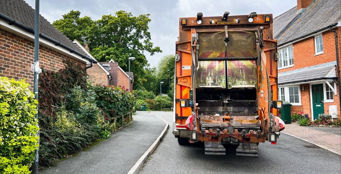 A bin collection lorry in a residential street
