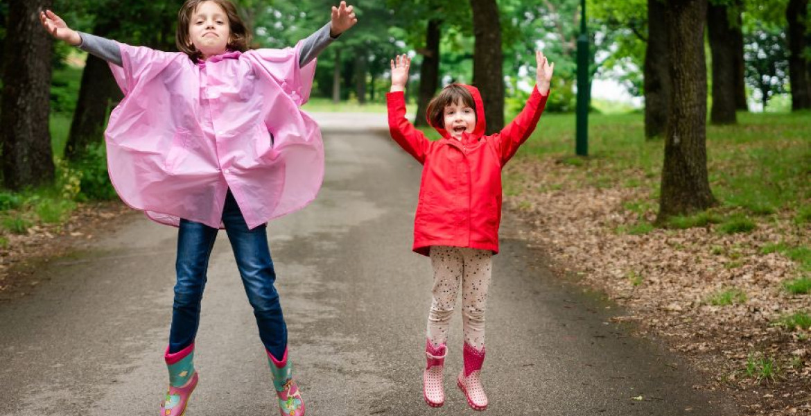 Two children jumping up in park
