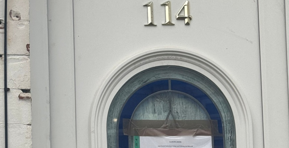 Photograph of the front door of a house that is the subject of the Closure Order