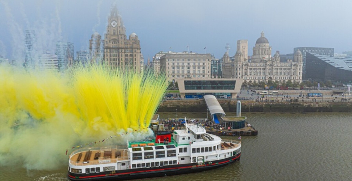 new mersey ferry in front of Liverpool waterfront's three graces