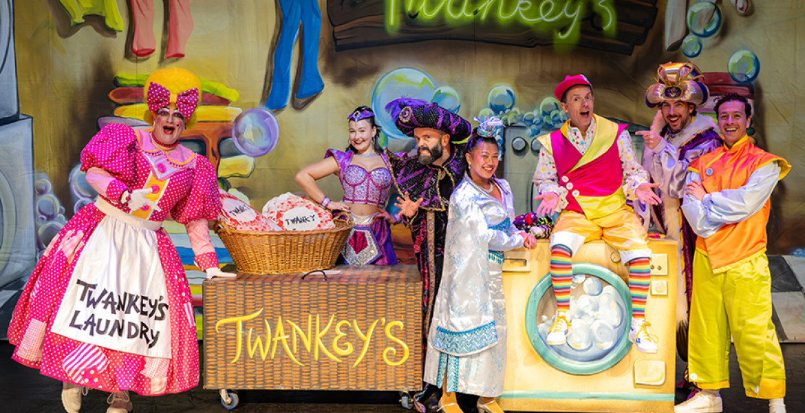 The cast of Aladdin grouped together on stage at the Floral Pavilion